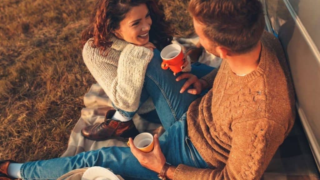 Couple enjoying an outdoor fall picnic