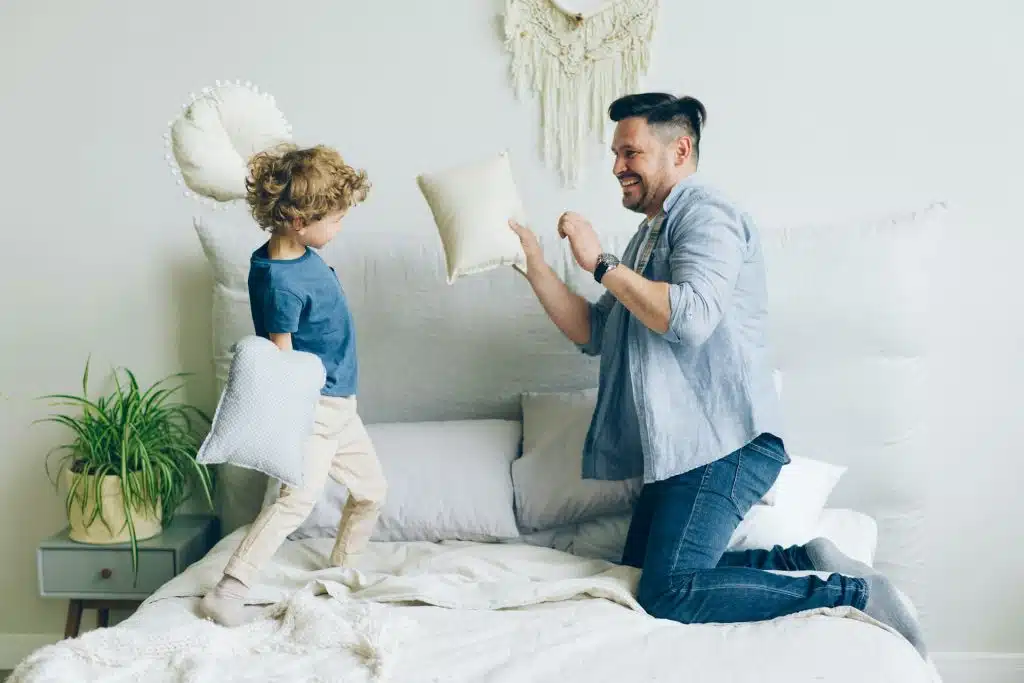 The man is playing with his son.