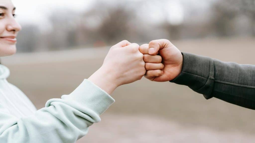 A couple fist bumping each other