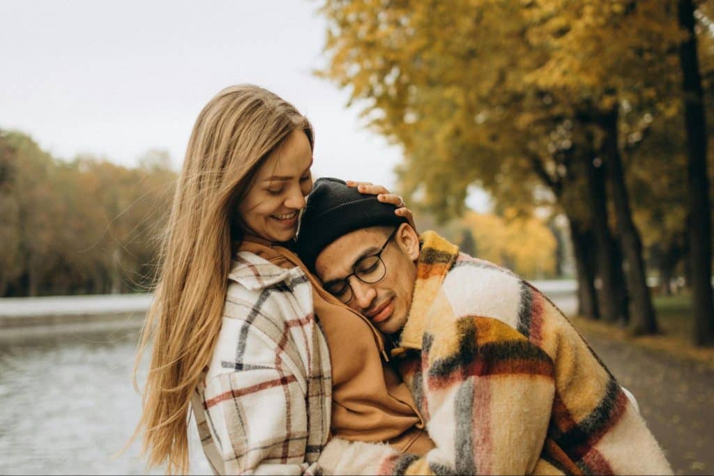A man leaning on woman