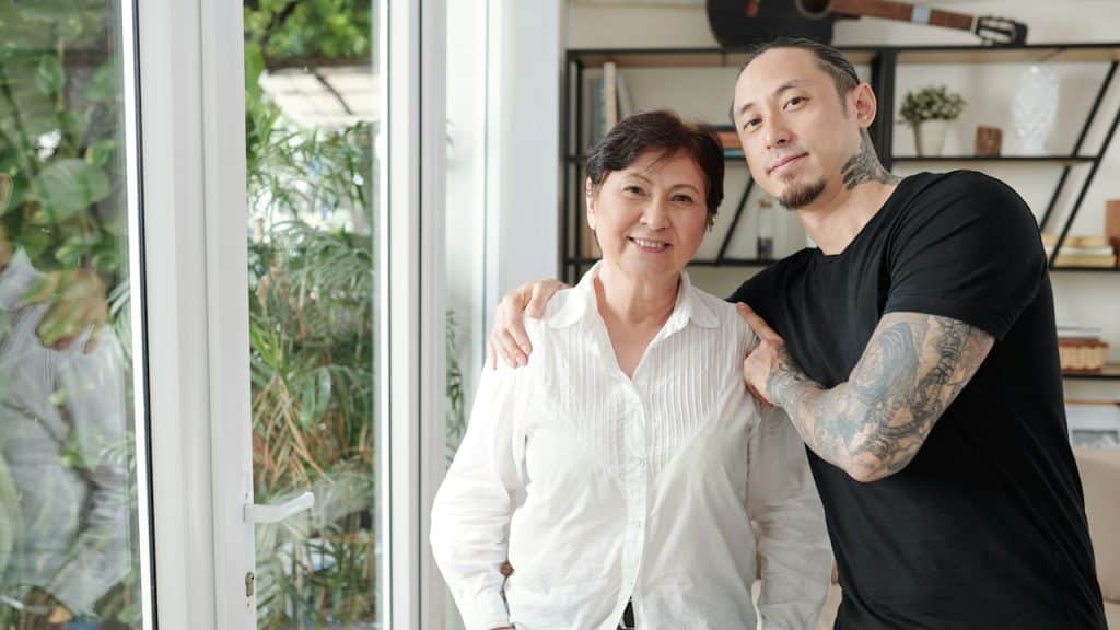 A man standing with his mother. 