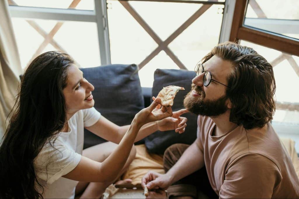 A woman feeding a man