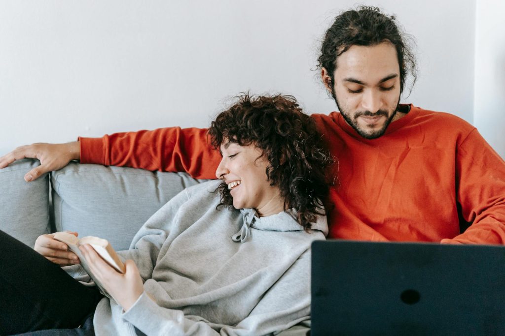 The couple is spending time together in the living room.