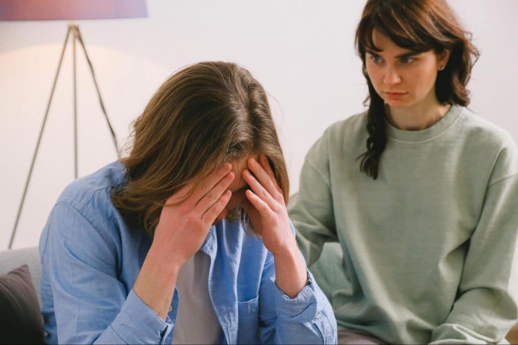 A woman apologizing to man