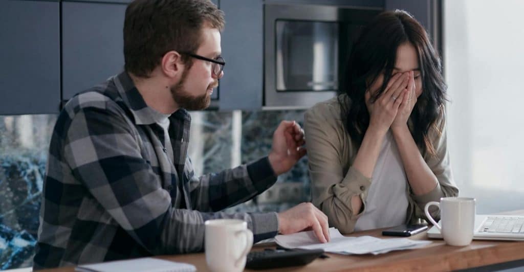 A man apologizing to woman