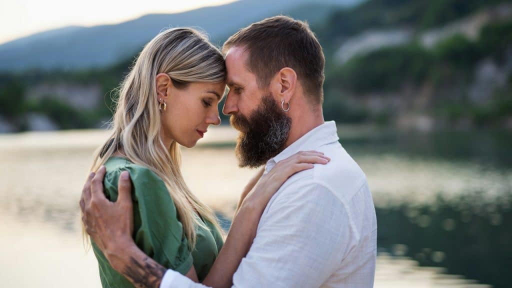 A couple touching foreheads.