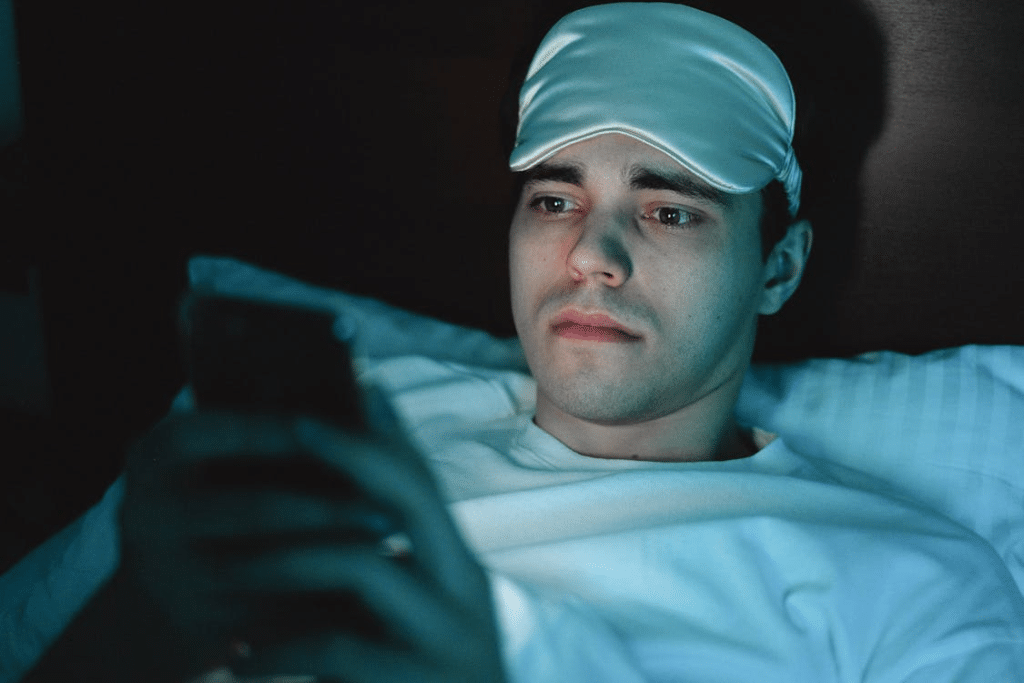 A Man in White Shirt with Sleeping Mask on His Head