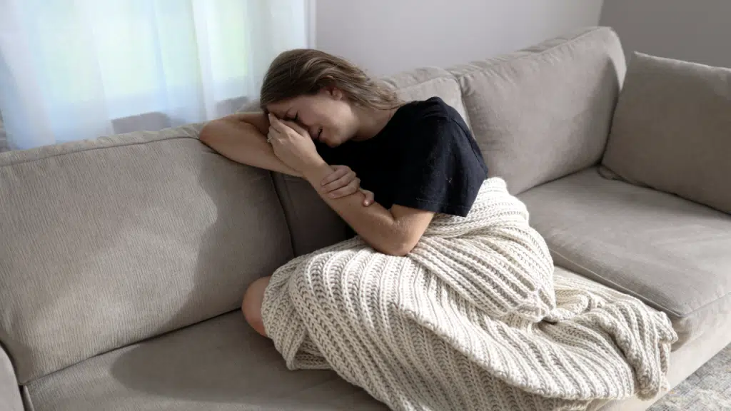 A woman crying on the couch