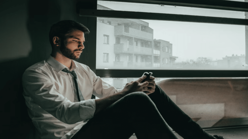 A man looking sad while texting