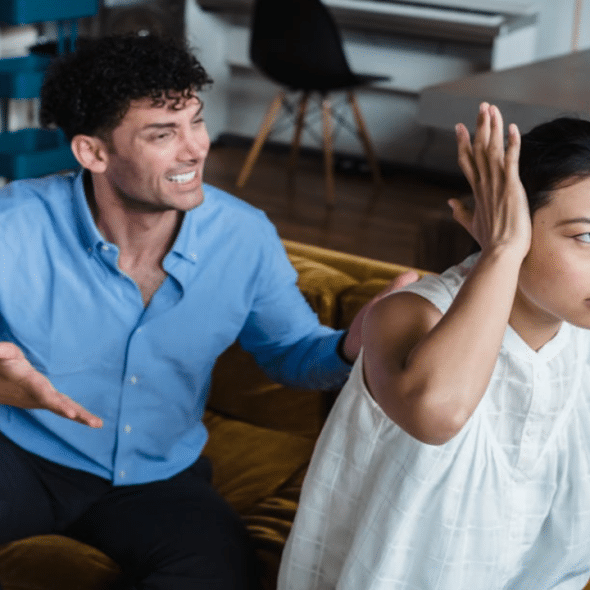 A couple fighting in the living room