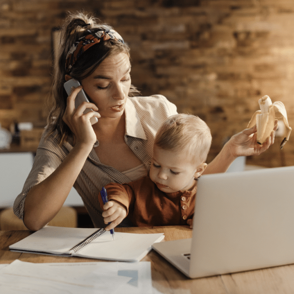 A mom working while taking care of her baby