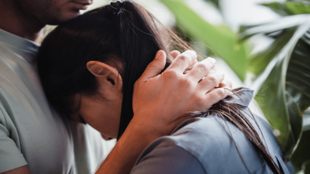 A couple hugging at home