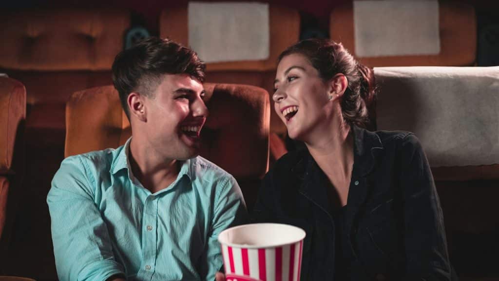 A Joyful Couple watching a movie in the cinema.