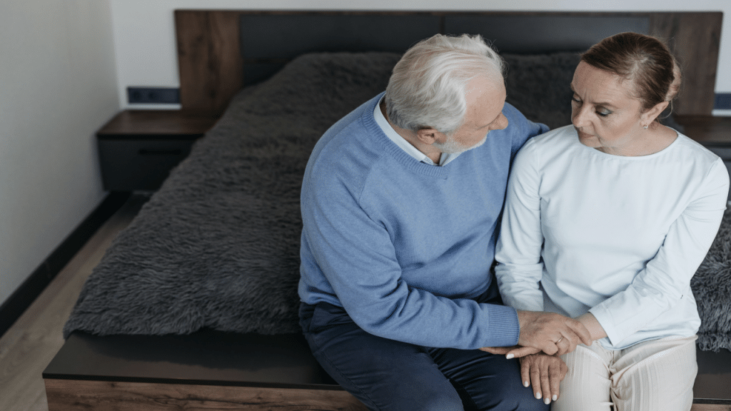 An elderly couple looking sad