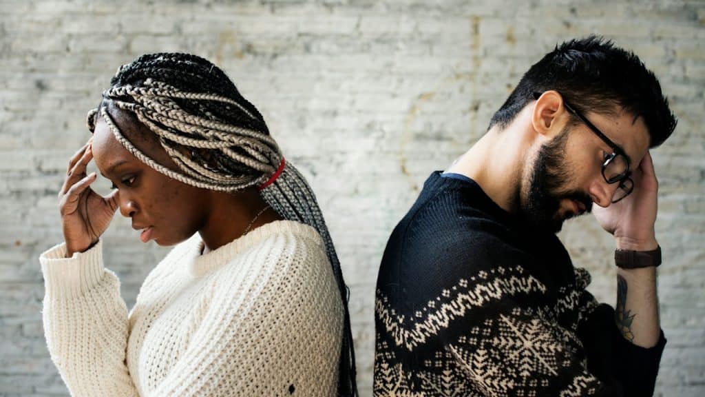A couple having a disagreement with their backs to each other.