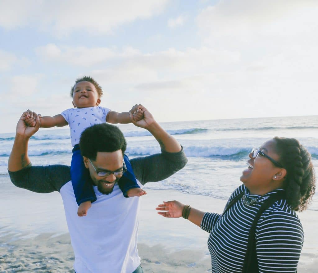 The young family is spending time at the beach.