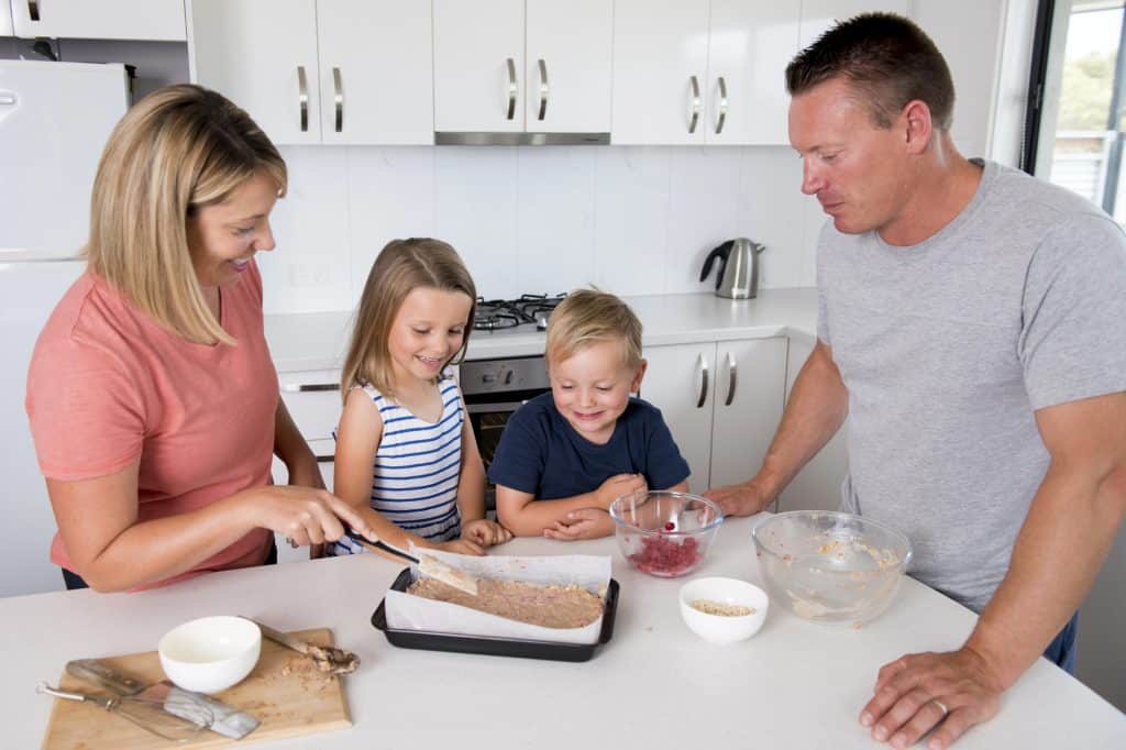 The family is baking in the kitchen.