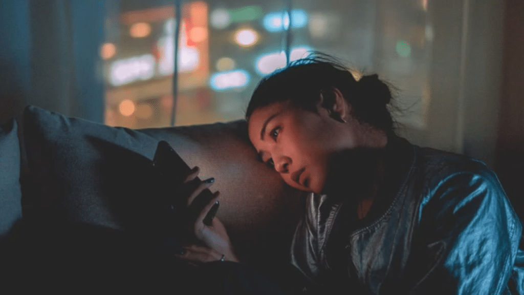 A woman looking sad while texting