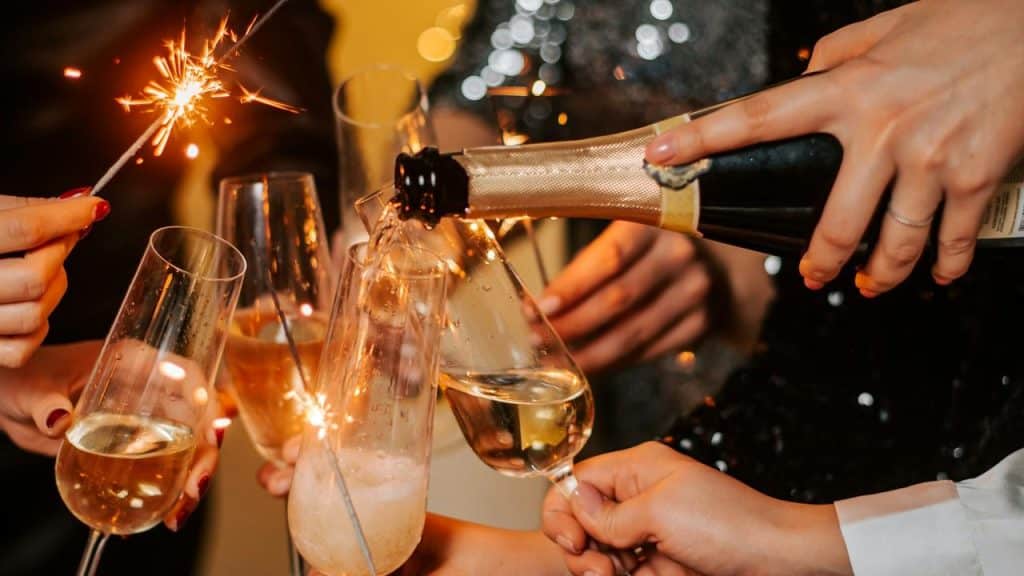 A group celebrating with champagne and sparklers.