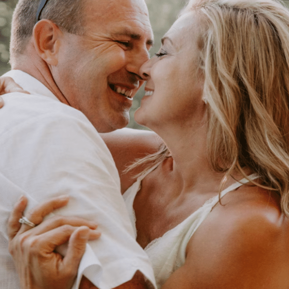 A mature couple kissing outdoors