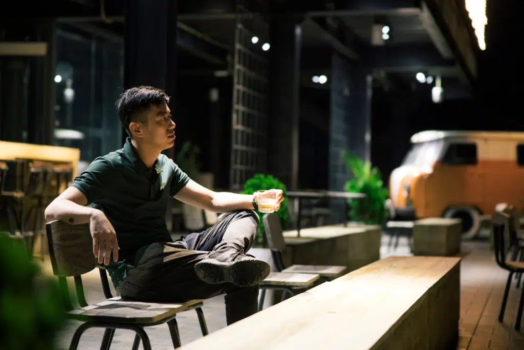 Man Sitting with a Drink in a Hip Sidewalk Cafe