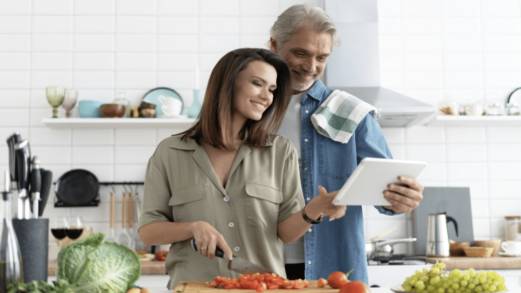 A couple looking at something on a tablet