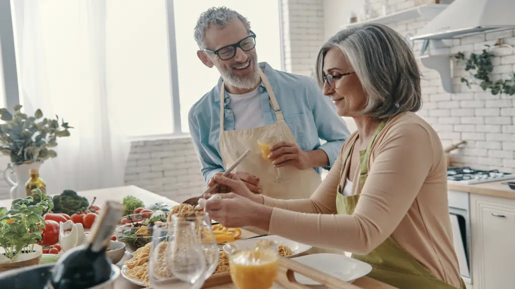 A couple cooking in the kitchen together