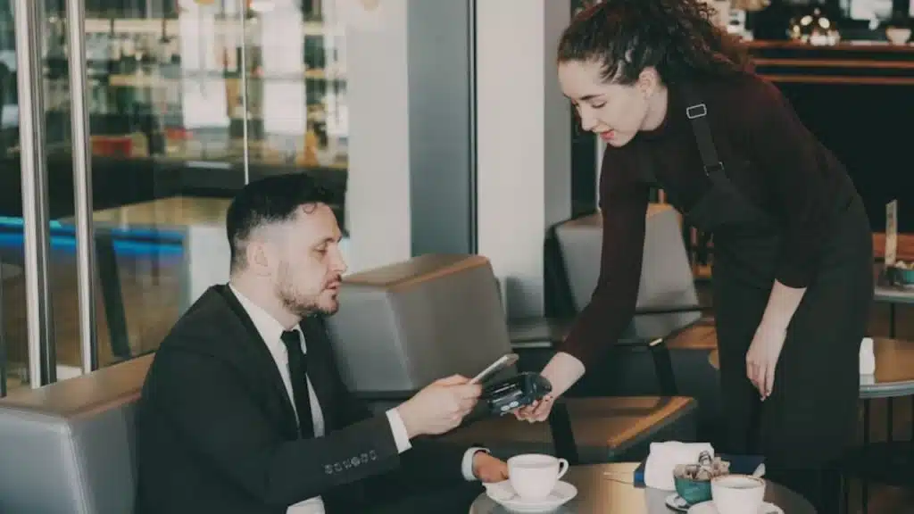 Couple at a restaurant with one person looking at a high bill
