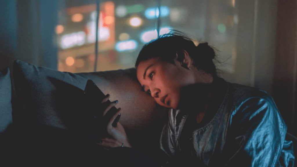A woman looking sad while texting