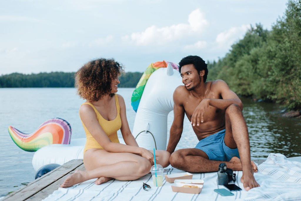 A Couple Having a Picnic Date on a Wooden Deck by the River