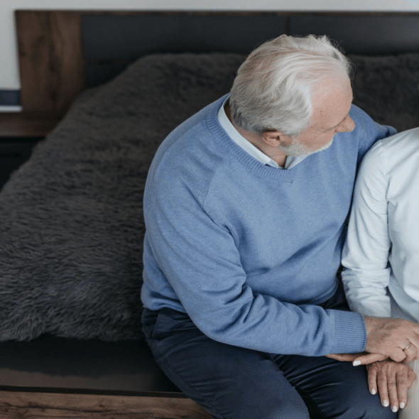 An elderly couple looking sad