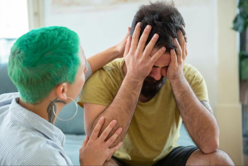 A woman comforting a man