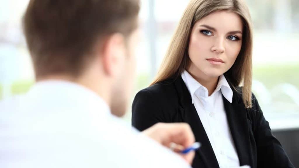 Woman observing her partner during a conversation, looking thoughtful