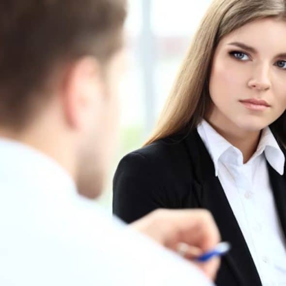 Woman observing her partner during a conversation, looking thoughtful