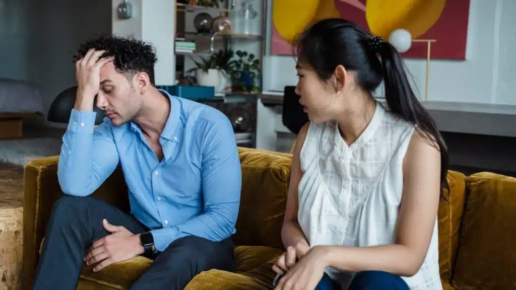 A man appearing to be physically and emotionally detached with his partner