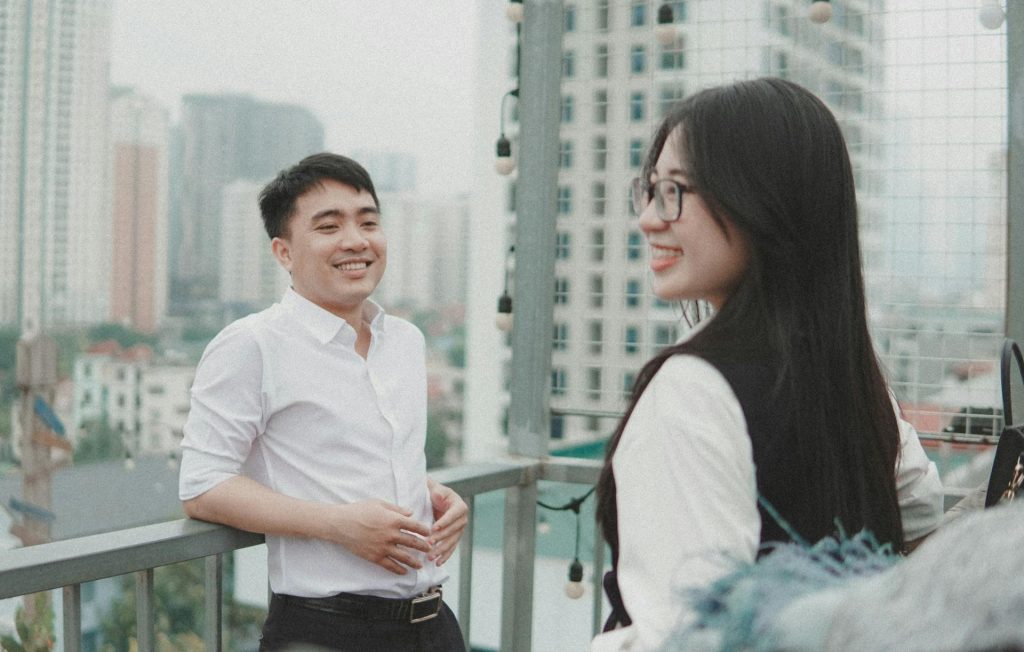 The man in a white shirt looks lovingly at the woman.