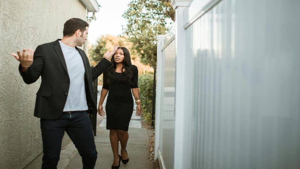 A couple arguing outside their home