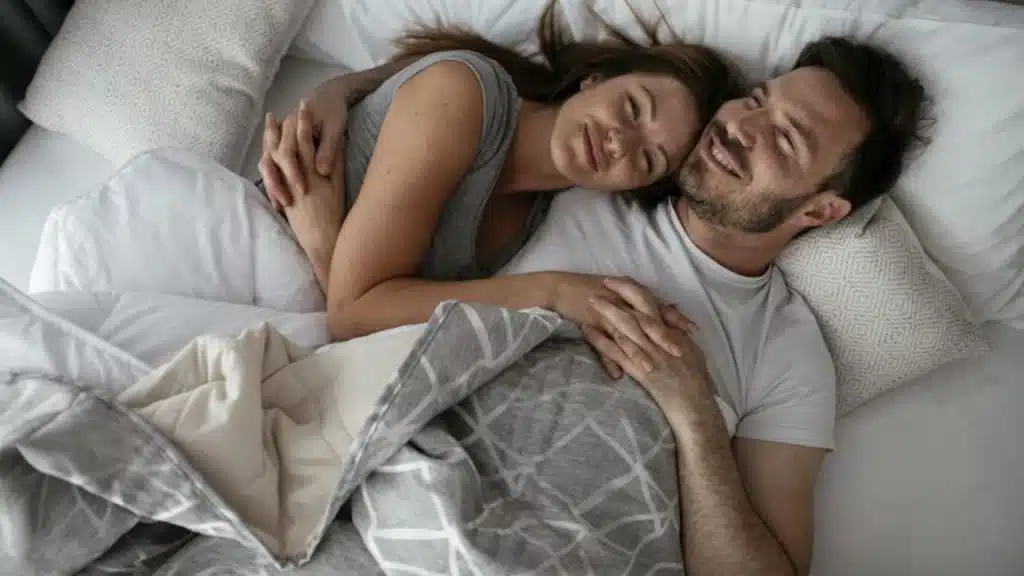 Couple cuddling and talking quietly at night