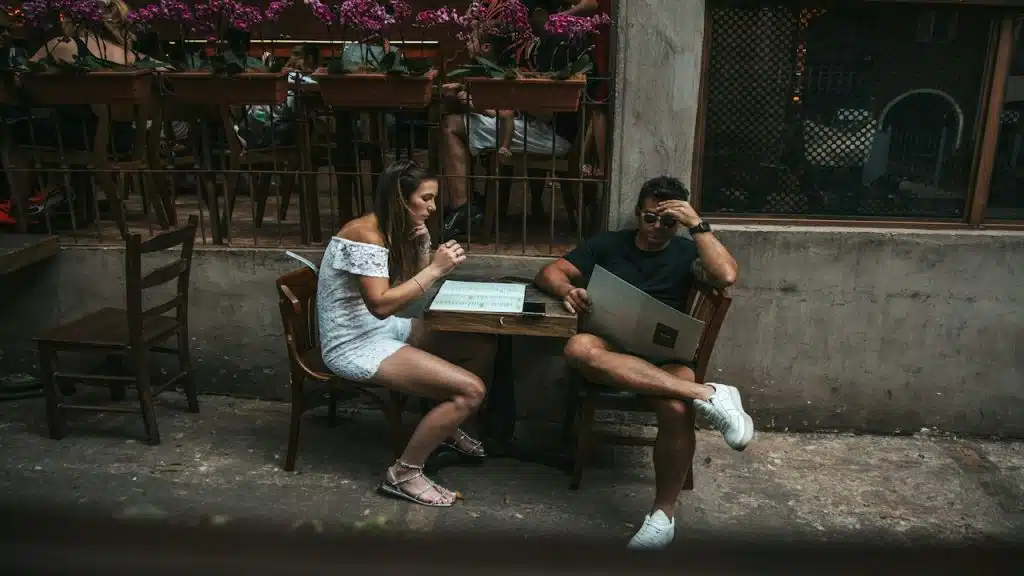 An unhappy couple sitting at a table.