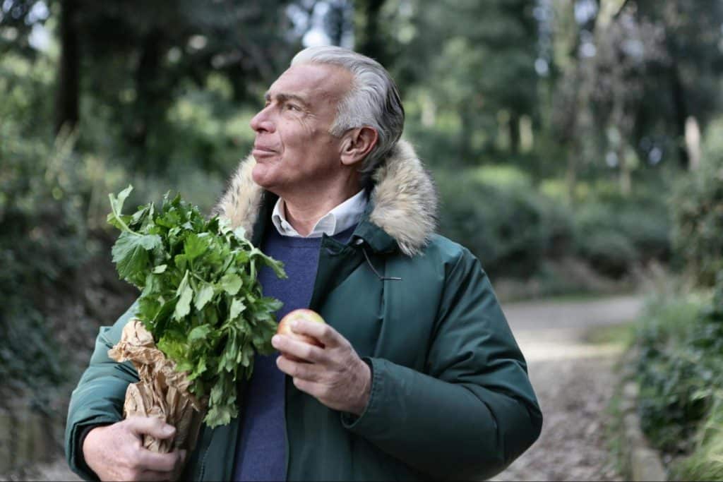 A man holding a green leaves