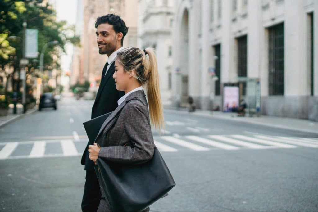 A man standing beside woman