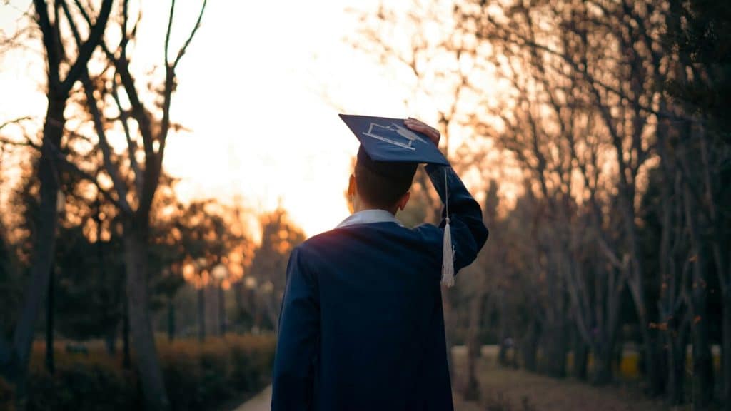 A man walking to his graduation alone