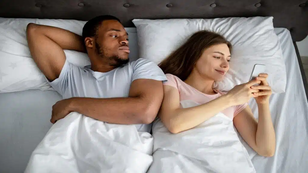 A woman ignoring her husband to use her phone