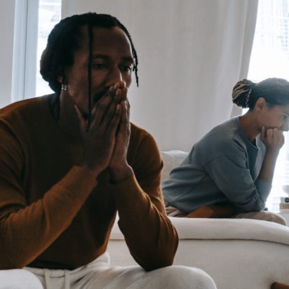 A couple looking sad in the bedroom