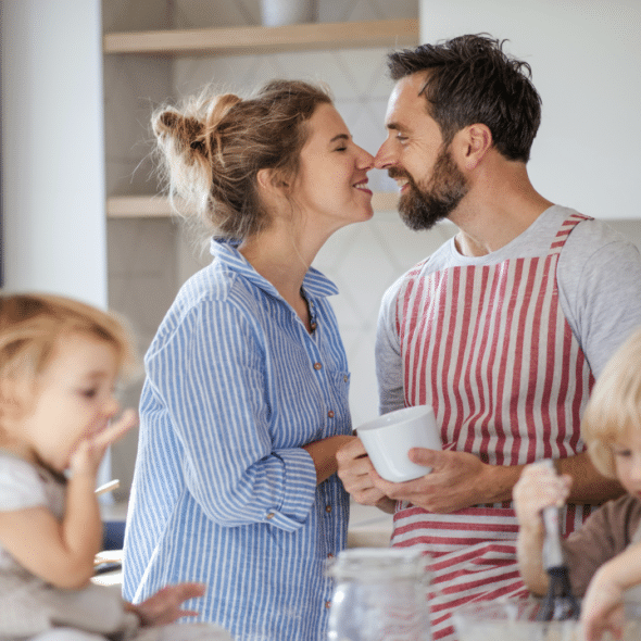 A couple kissing in the kitchen