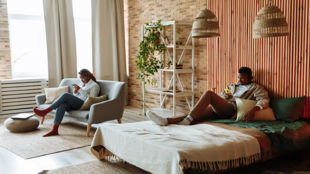 A couple ignoring each other in the bedroom
