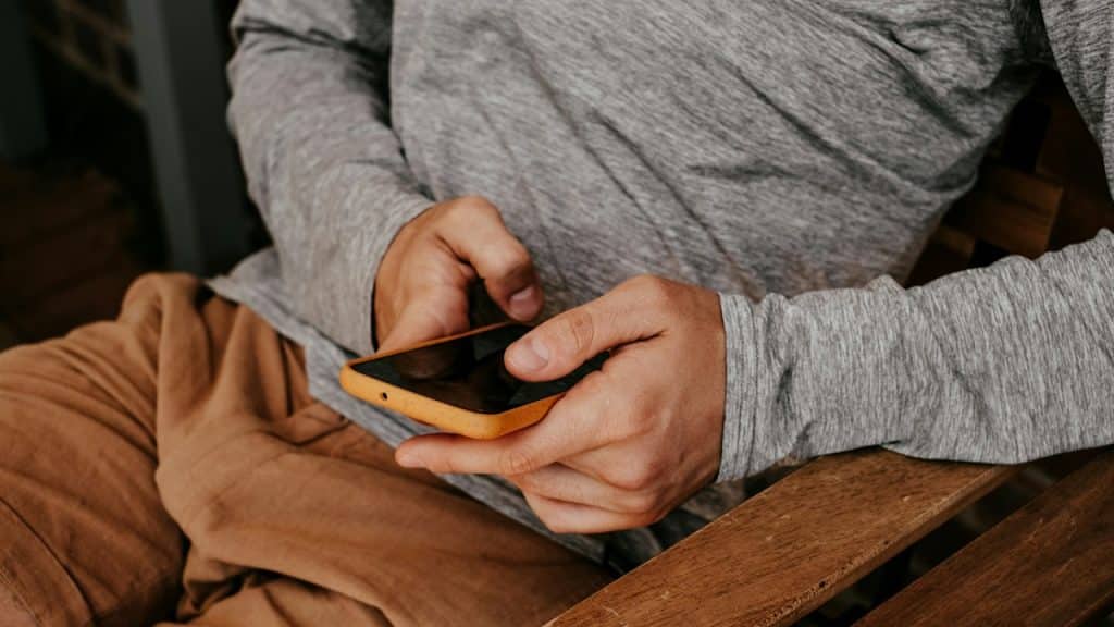 A man sitting and texting someone.