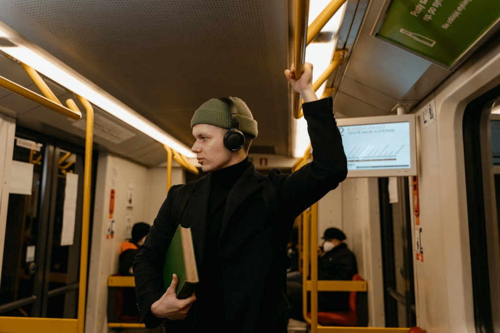 A Man Listening to Music while Riding a Train