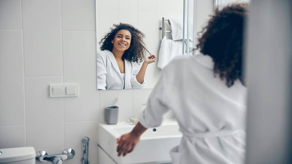 A woman looking at herself in the mirror