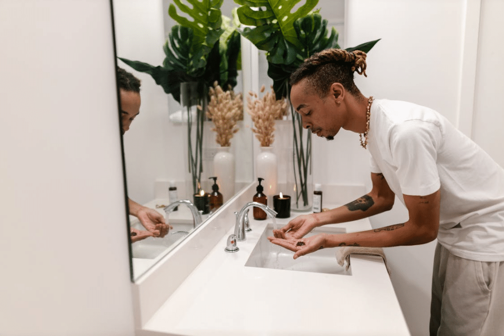 Man Washing Face in Bathroom